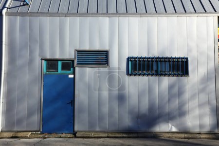 Photo for Industrial fasade with blue door - Royalty Free Image