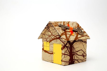 Photo for Cardboard house with glued key on white background - Royalty Free Image