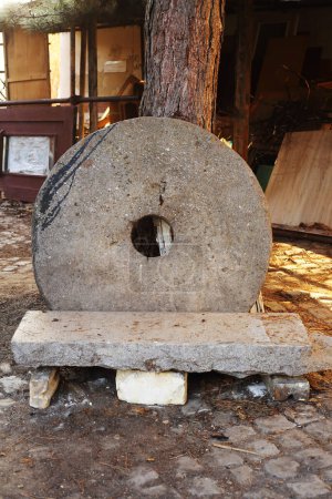 old stone mill wheel in the yard