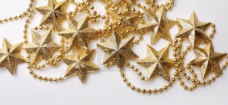 Photo for Gold star garland frame on light beige empty copy space horizontal background. - Royalty Free Image