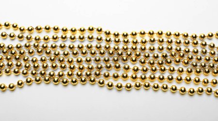 Photo for Gold round beads garland on white backgroun. Flat lay.  Top view. - Royalty Free Image