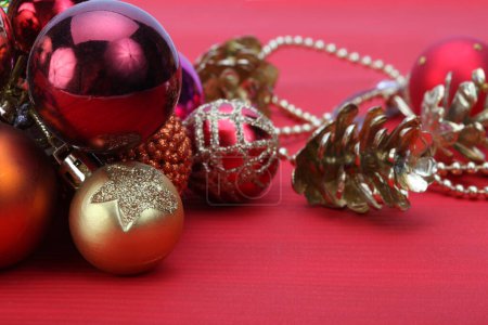 Photo for Close-up Christmas glow shine glitter decoration balls on red copy space horizontal background. - Royalty Free Image