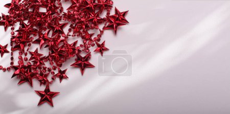 Photo for Red star garland fon light and shadow beige empty copy space horizontal background. - Royalty Free Image