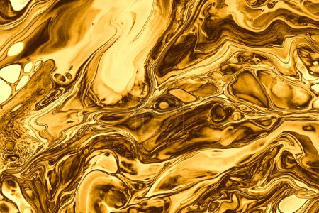 Foto de Abstract flow gold and bronze pour flow marble blot wave. Color copy space smoke horizontal texture background. - Imagen libre de derechos