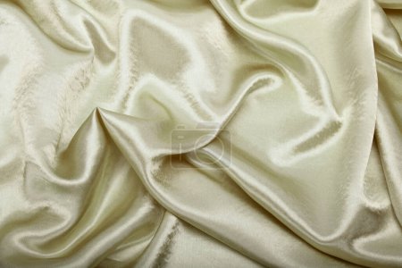 Foto de Beige pearl wave fabric silk. Abstract texture horizontal copy space background. - Imagen libre de derechos