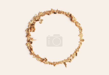 Foto de Gold (bronze) glitter empty ring circle frame on beige gray paper background. Abstract copy space texture. - Imagen libre de derechos