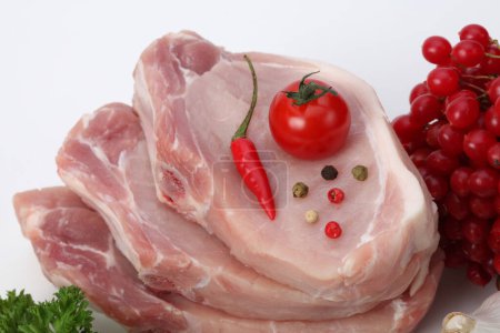 Foto de Pork meat with vegetables on light background. - Imagen libre de derechos