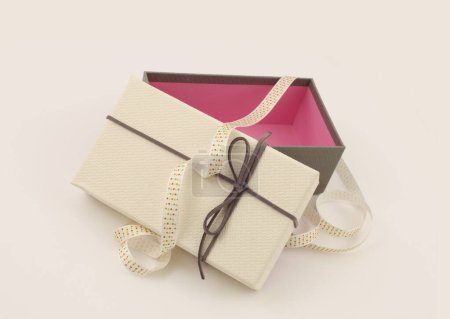 Photo for Craft empty gift box with ribbon  on light beige background. Copy space minimalism style template background. - Royalty Free Image