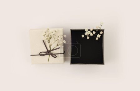 Photo for Craft gift boxes with flower on light beige background. Copy space minimalism style template background. - Royalty Free Image