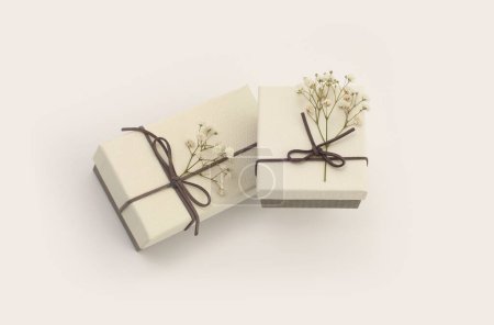 Foto de Craft gift boxes with flower on light beige background. Copy space minimalism style template background. Top view - Imagen libre de derechos
