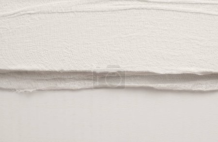 Téléchargez les photos : Empty crumpled wet canvas fabric blank texture copy space wave background. Gray beige  color. - en image libre de droit