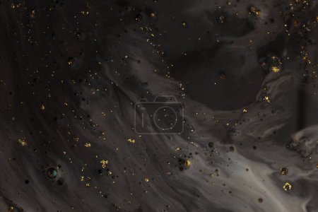 Photo for Flow pour oil and acrylic color painting blot. Abstract black and gold glitter texture background. - Royalty Free Image