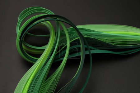 Photo for Green color strip wave curve paper line on black. Abstract texture background. - Royalty Free Image