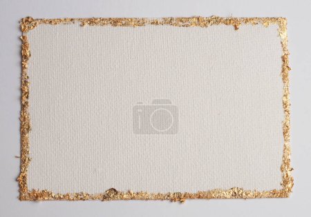 Téléchargez les photos : Gold (bronze) glitter empty canvas frame on beige gray paper background. Abstract copy space texture. - en image libre de droit
