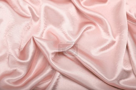 Foto de Beige pink pearl wave fabric silk. Abstract texture horizontal copy space background. - Imagen libre de derechos