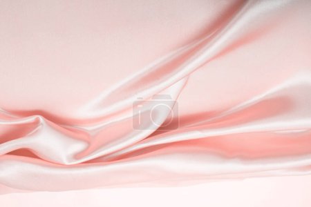 Téléchargez les photos : Beige pink nacre wave fabric silk. Abstract texture horizontal copy space background. - en image libre de droit