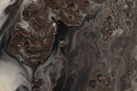 Photo for Flow pour wave oil and acrylic color painting blot and drop wall. Abstract swirl black and bronze texture background. - Royalty Free Image