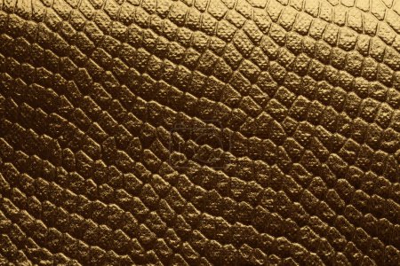 Foto de Oro y bronce oro, papel de brillo de bronce. Abstracto reptil piel imitación textura fondo. - Imagen libre de derechos