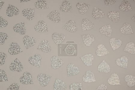 Photo for Beige crumpled craft paper blank with silver glitter heart dots. Texture copy space background. - Royalty Free Image