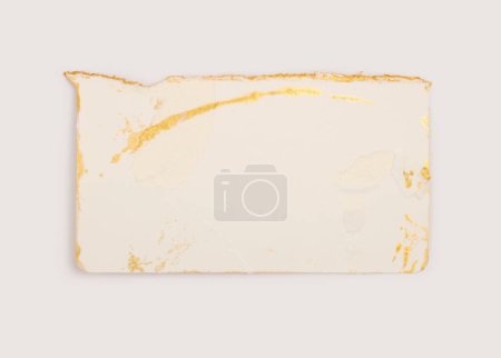 Foto de Torn empty old grunge pieces texture cardboard paper on neutral background. Beige and gold color. - Imagen libre de derechos