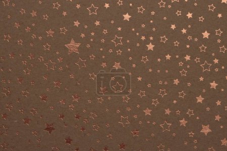 Foto de Scrapbook beige brown paper blank with star gold pattern. Texture relief copy space wallpaper background. - Imagen libre de derechos