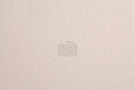 Téléchargez les photos : Scrapbook beige paper blank with flower leaf pattern. Texture relief copy space wallpaper background. - en image libre de droit