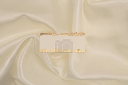 Photo for Gold glitter empty canvas paper frame label on beige silk fabric background. Abstract copy space texture. - Royalty Free Image