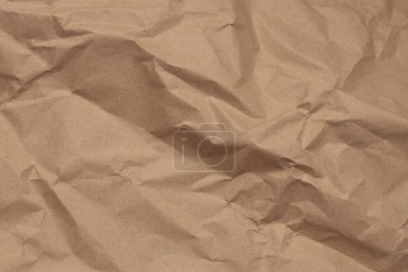 Beige crumpled package old craft paper blank texture copy space background.