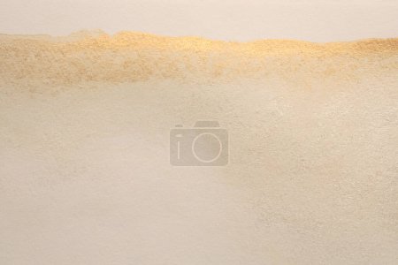 Photo for Gold glitter Ink watercolor grain blot on beige paper texture background. - Royalty Free Image