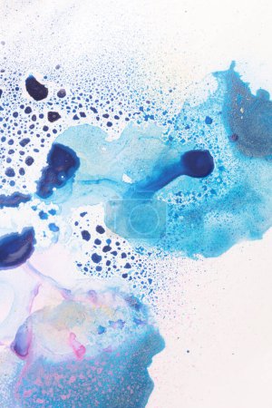 Photo for Ink Watercolor flow blot drops splash blue color stain on gray paper texture background. - Royalty Free Image