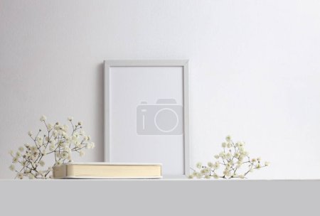 Photo for Office table (shelf) with empty frame and flowers. Copy space creative ligt beige gray neutral workspace. - Royalty Free Image