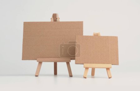 Photo for Empty copy space paper canvas on small wood easel. Art Light beige background. - Royalty Free Image