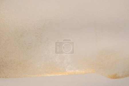 Photo for Gold silver nacre glitter Ink watercolor grain blot on beige empty paper texture background. - Royalty Free Image