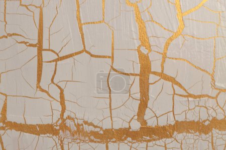 Craquelure scratch relief texture painting wall background. Gold, bronze, beige white color.