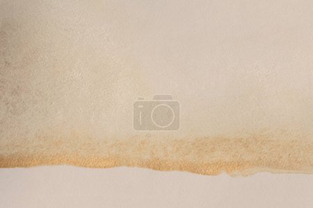Photo for Gold glitter Ink watercolor blot on beige grain empty paper texture background. - Royalty Free Image