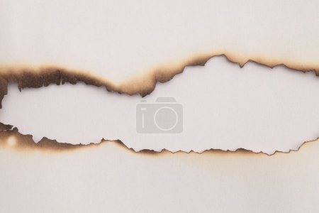 Photo for Empty old torn burned grunge pieces texture cardboard paper hole on beige white background. - Royalty Free Image