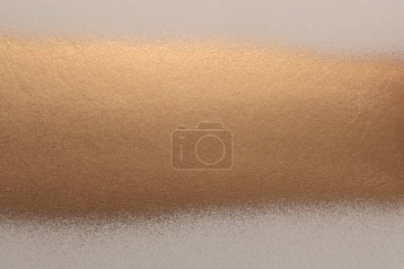 Gold and bronze spray grain painting texture paper wall background.