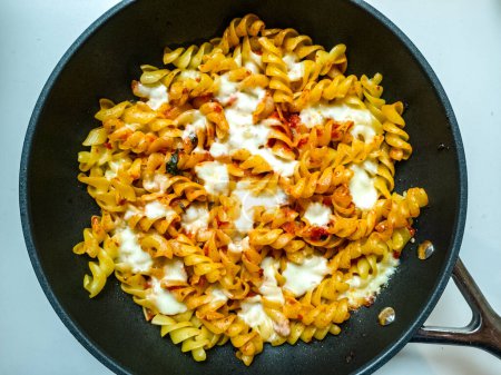 Fusilli pasta with tomato sauce and mozzarella, cooked in the oven - italian recipe