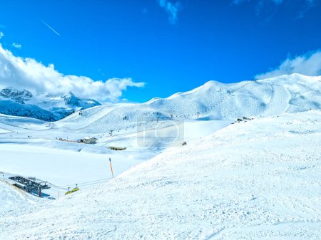 Obertauern, Salzburg area, Austria - Ski resort, hut, skiers and slope in Austrian Alps