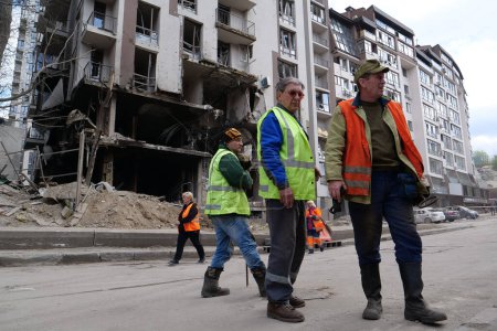 Photo for KYIV, UKRAINE, APRIL 29, 2022: Workers clear rubble after bombing. Dwelling house damaged by russian missile on April 28, 2022. War in Ukraine. Terror and genocide of Ukrainian people - Royalty Free Image