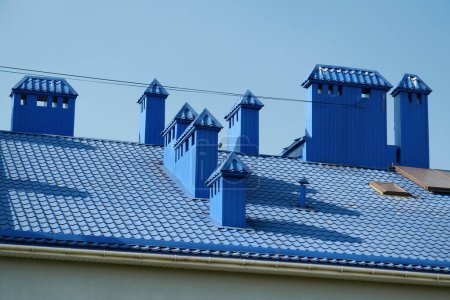 Photo for Blue roof of building with tiles and ventilation tubing - Royalty Free Image