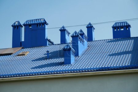 Photo for Blue roof of building with tiles and ventilation tubing - Royalty Free Image