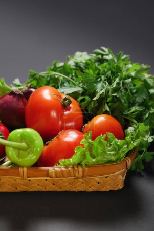 Photo for Parsley leaves,lettuce and  bio tomato in basket.   vegan salad ingredients - Royalty Free Image