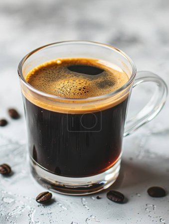 Black coffee in a glass cup stands out against a bright, minimalist backdrop, emphasizing simplicity and purity