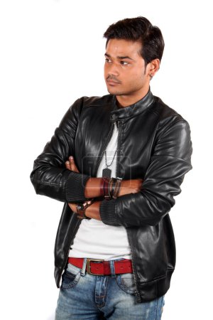 Photo for A young handsome Indian guy intently watching someone, on white studio background. - Royalty Free Image