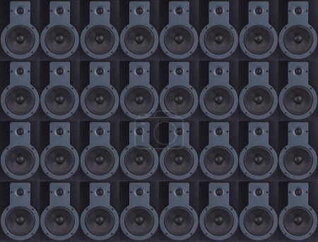 A background of a multi layer of professional studio speakers or studio monitors of black color.