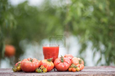 Photo for Fresh tomato juice, on a wooden background - Royalty Free Image