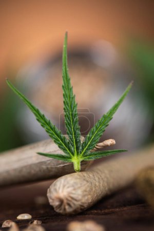 Photo for Cannabis leaf and hemp on a wooden board - Royalty Free Image