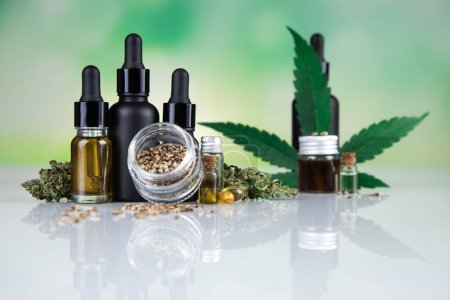 Photo for Marijuana oil in bottles and hemp seeds with cannabis leaf on white background with copy space. alternative medicine. - Royalty Free Image