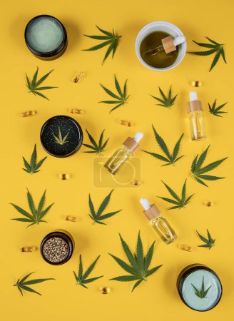 Photo for Flat lay with marijuana oil bottles on yellow background. flat lay - Royalty Free Image